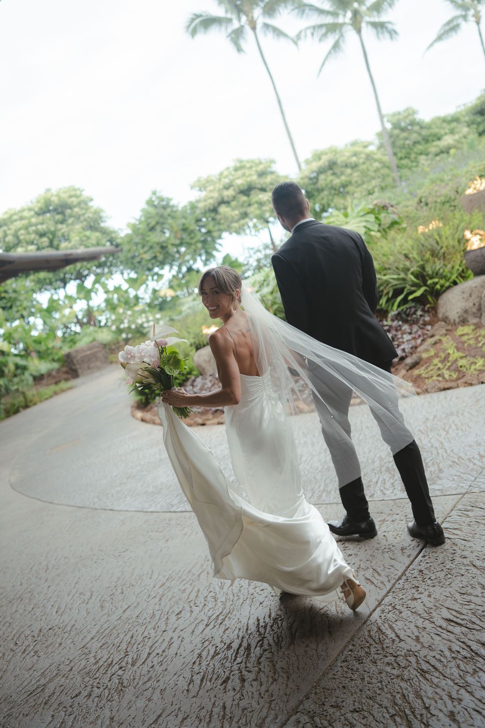 Bride and Groom walking at 1 Hotel Hanalei Bay