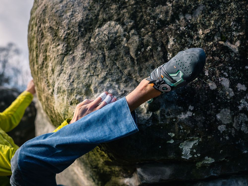 Alexander Megos placing Tenaya Aruma shoe on Fontainebleau sandstone. Climbing photography by Jan Virt, France.