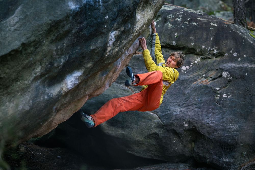 Alexander Megos climbing a steep overhang on Fontainebleau sandstone during the Tenaya Aruma campaign. Photo by Jan Virt.