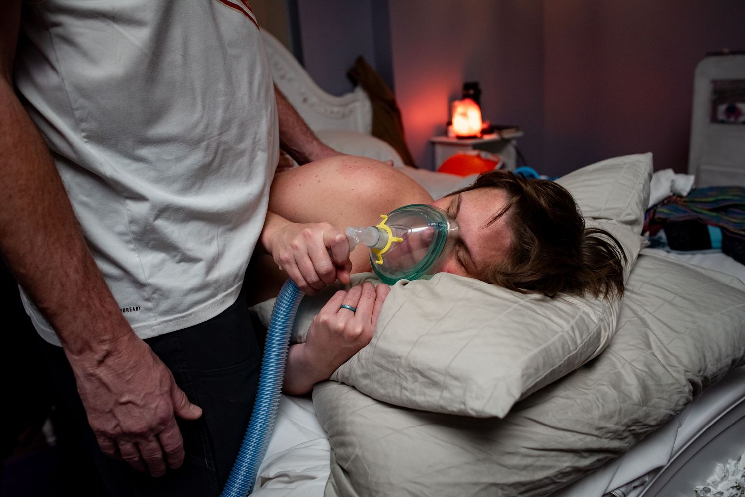 A chiropractor performs spinal adjustment therapy on a patient lying on a treatment table.