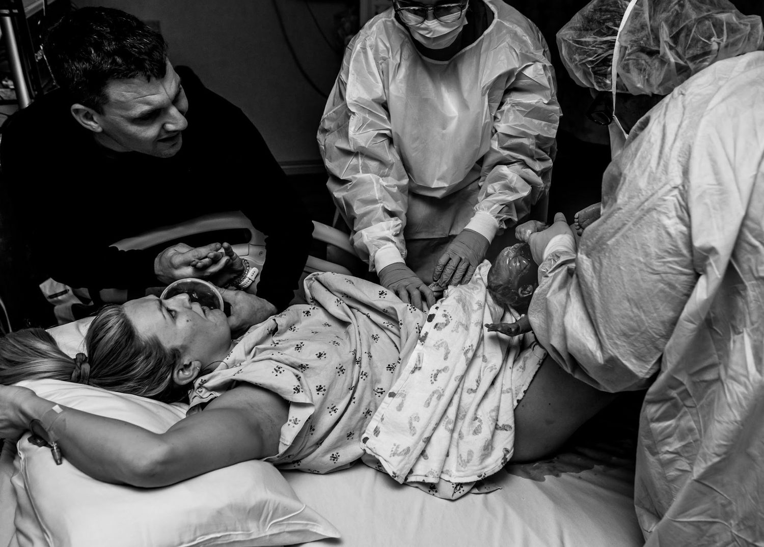 Medical staff attending to mother during the delivery of her baby