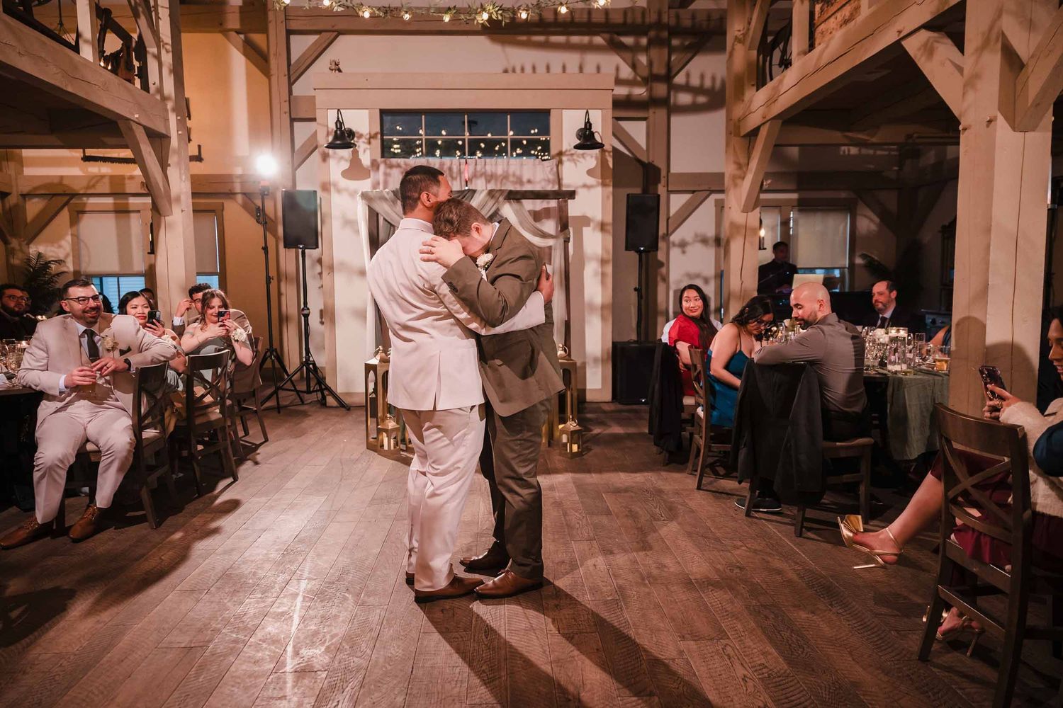 Grooms sharing an emotional moment during their first dance at Briar Barn Inn wedding reception