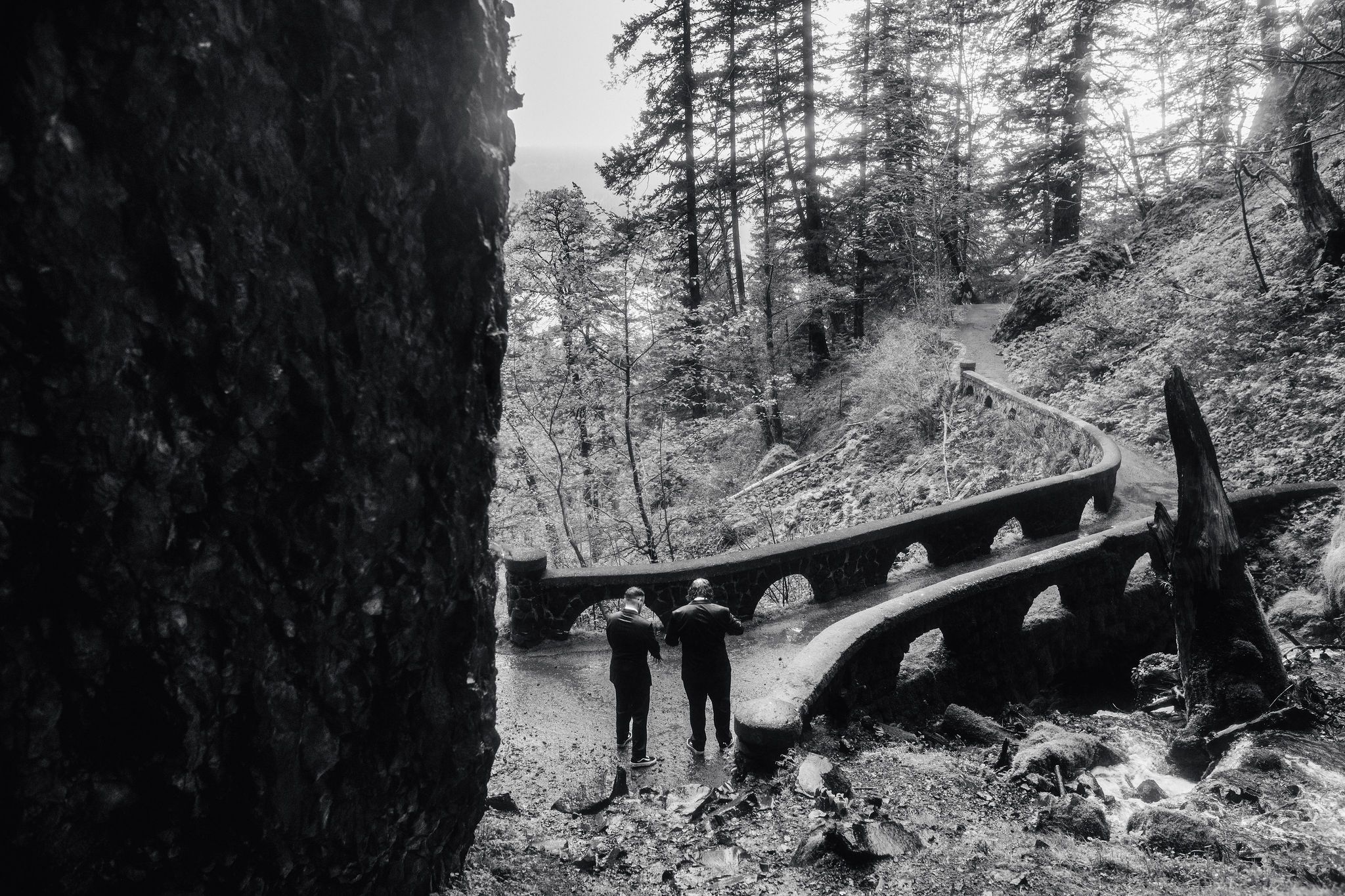 Couple about to cross the bridge after an elopement at Wahkeena Falls
