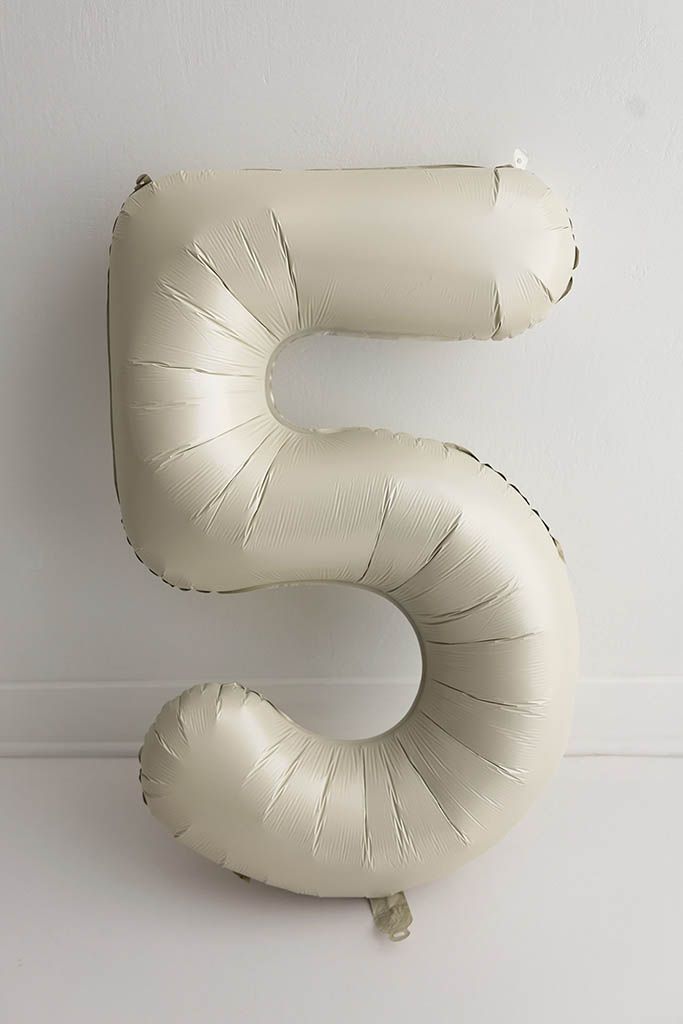 Cream matte number 5 foil balloon against a white background for 5th birthday photoshoot in Menifee.