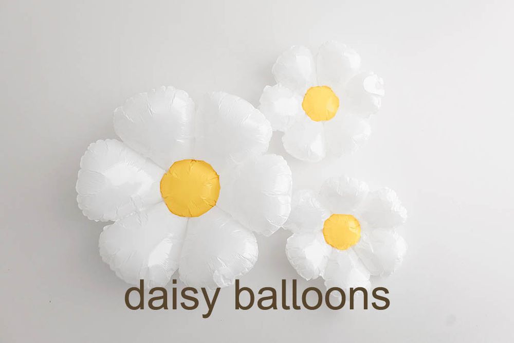 Three white daisy flower foil balloons with yellow centers labeled daisy balloons on white background.
