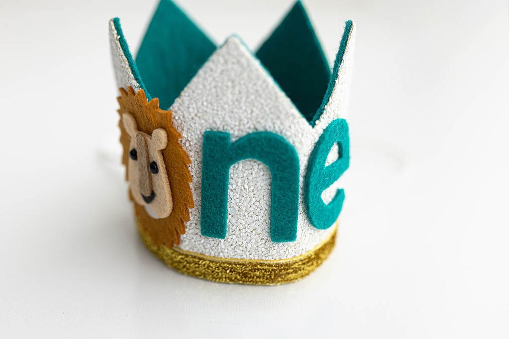 Silver and teal glitter first birthday crown with lion, First Birthday Photographer in Wildomar, California.