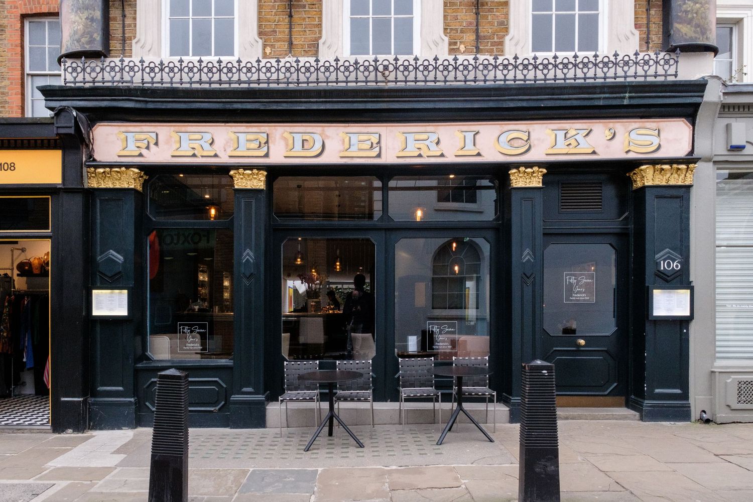 Exterior of Frederick's restaurant with dark green facade, gold signage, and large windows on a London street.