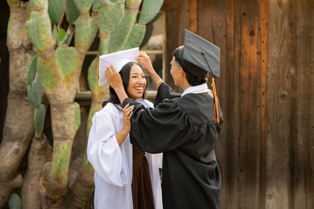 Graduation photos featuring academic regalia against weathered wooden backdrop.