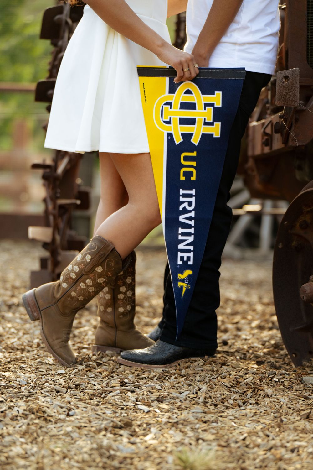 Brown boots and UC Irvine branded socks shown against rustic ground setting.
