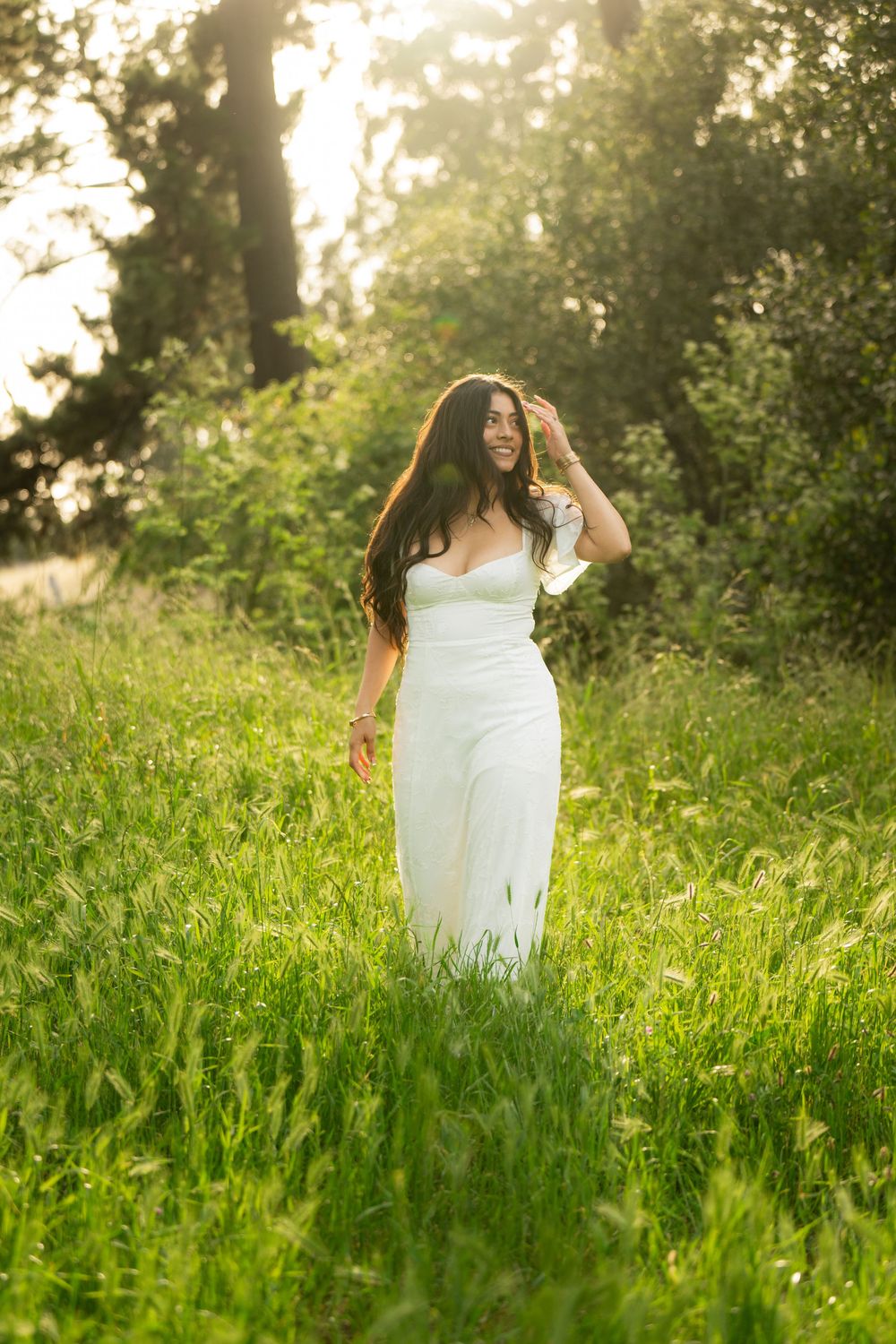 White sundress contrasts beautifully against lush green grass in a sunny outdoor setting.