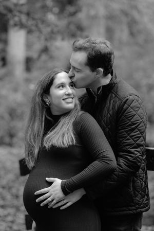 A romantic black and white photo series showing a couple embracing and sharing tender moments in an outdoor setting.