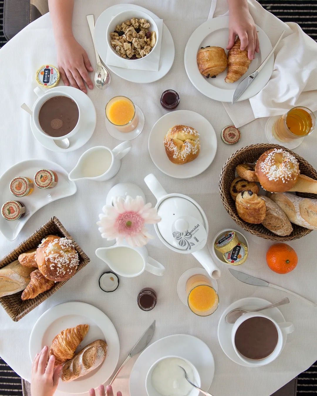 A family breakfast flatlay with pastries, fruit, coffee and shared morning moments.