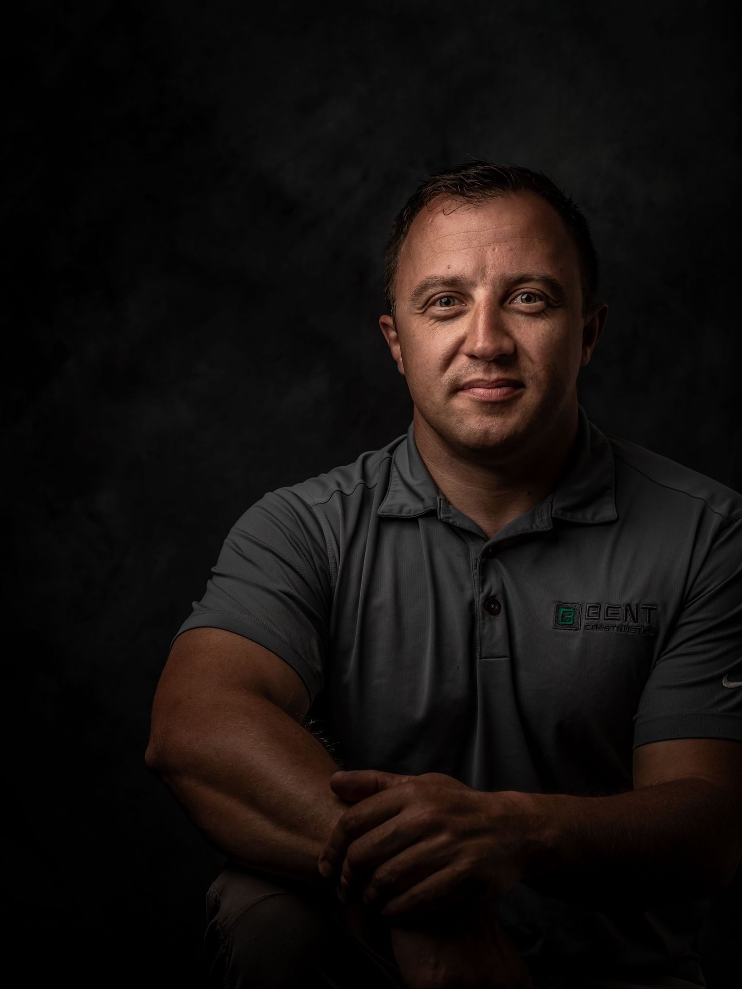 Dramatic black and white portrait series showing a person in a gray polo shirt against dark background.