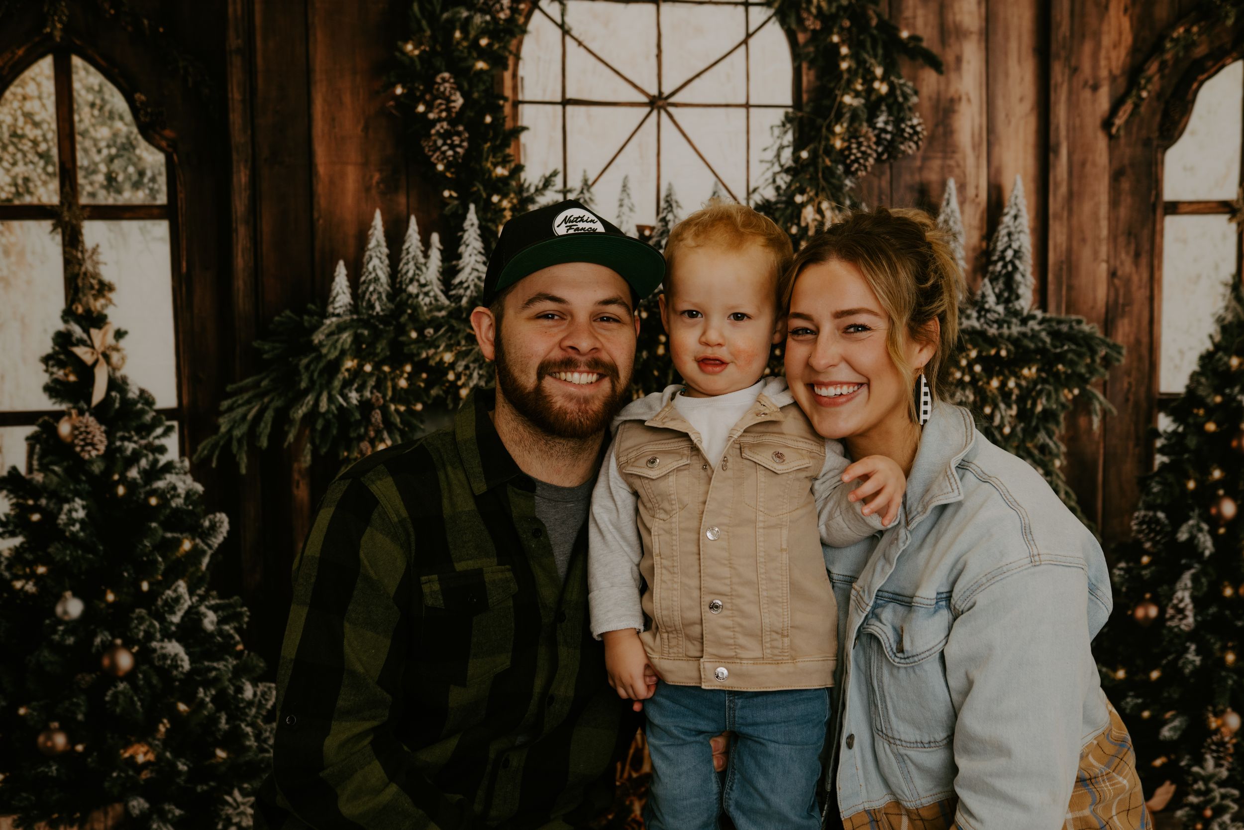 Candid family moments captured against festive indoor holiday setting.