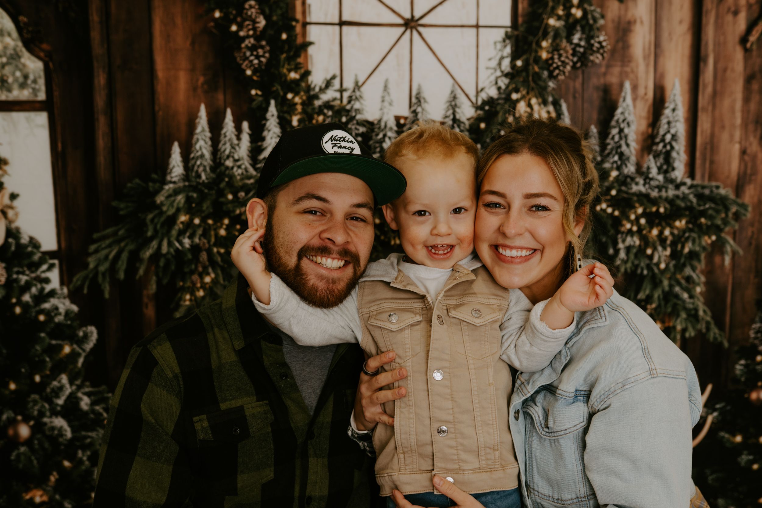 Family shares joyful moments during indoor holiday photo session.
