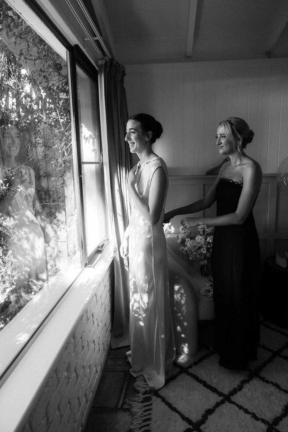 A sequence of black and white photos showing someone looking through a window in different poses and lighting conditions.