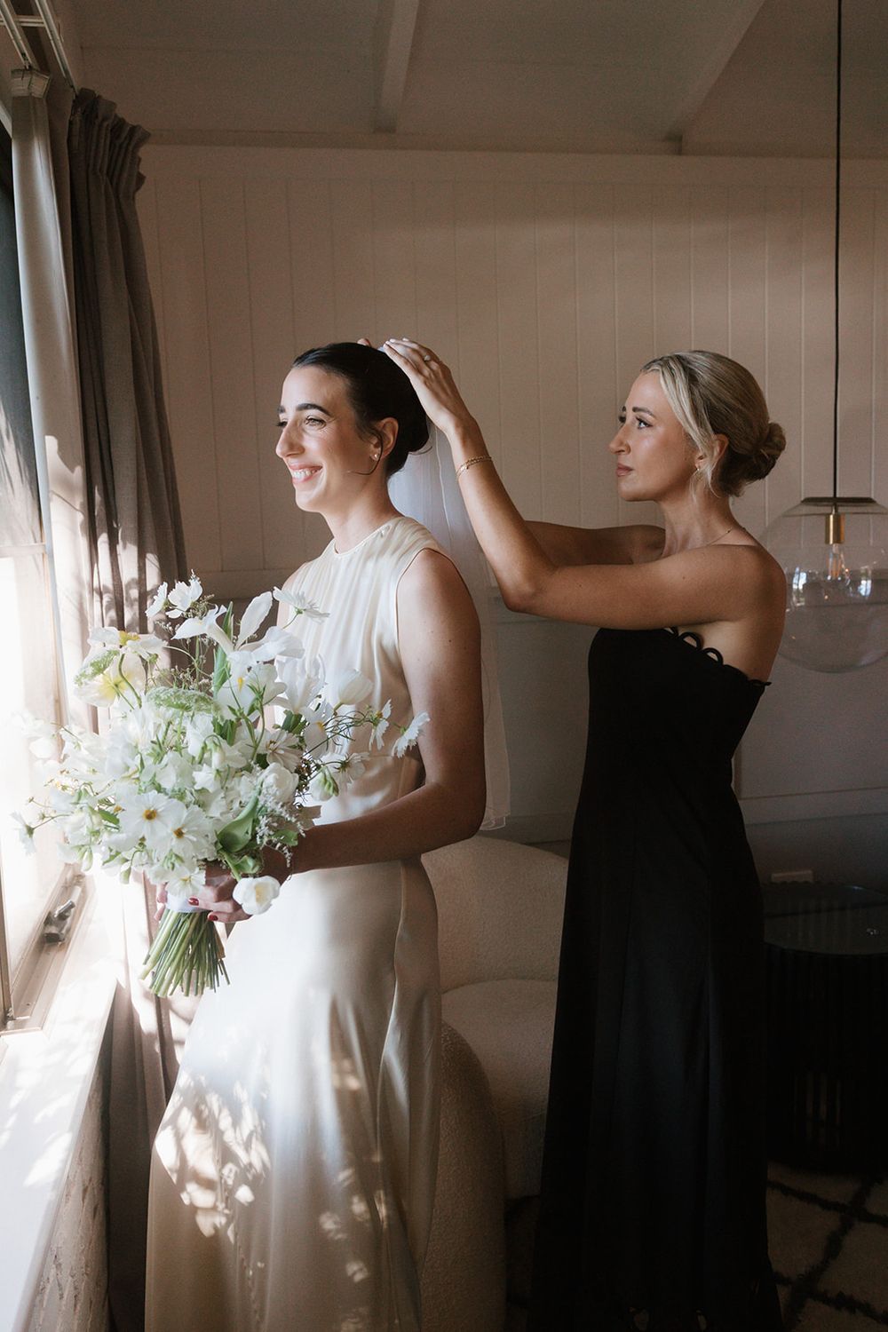 A series of wedding preparation moments showing a bride in a white dress getting ready by a sunlit window.