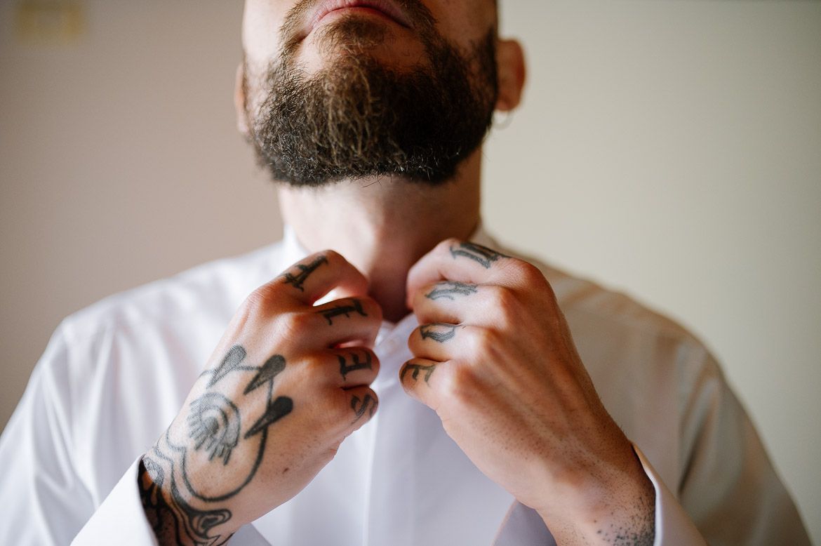 A person in a white shirt holds their hand up to their nose in a sequence of five similar poses.