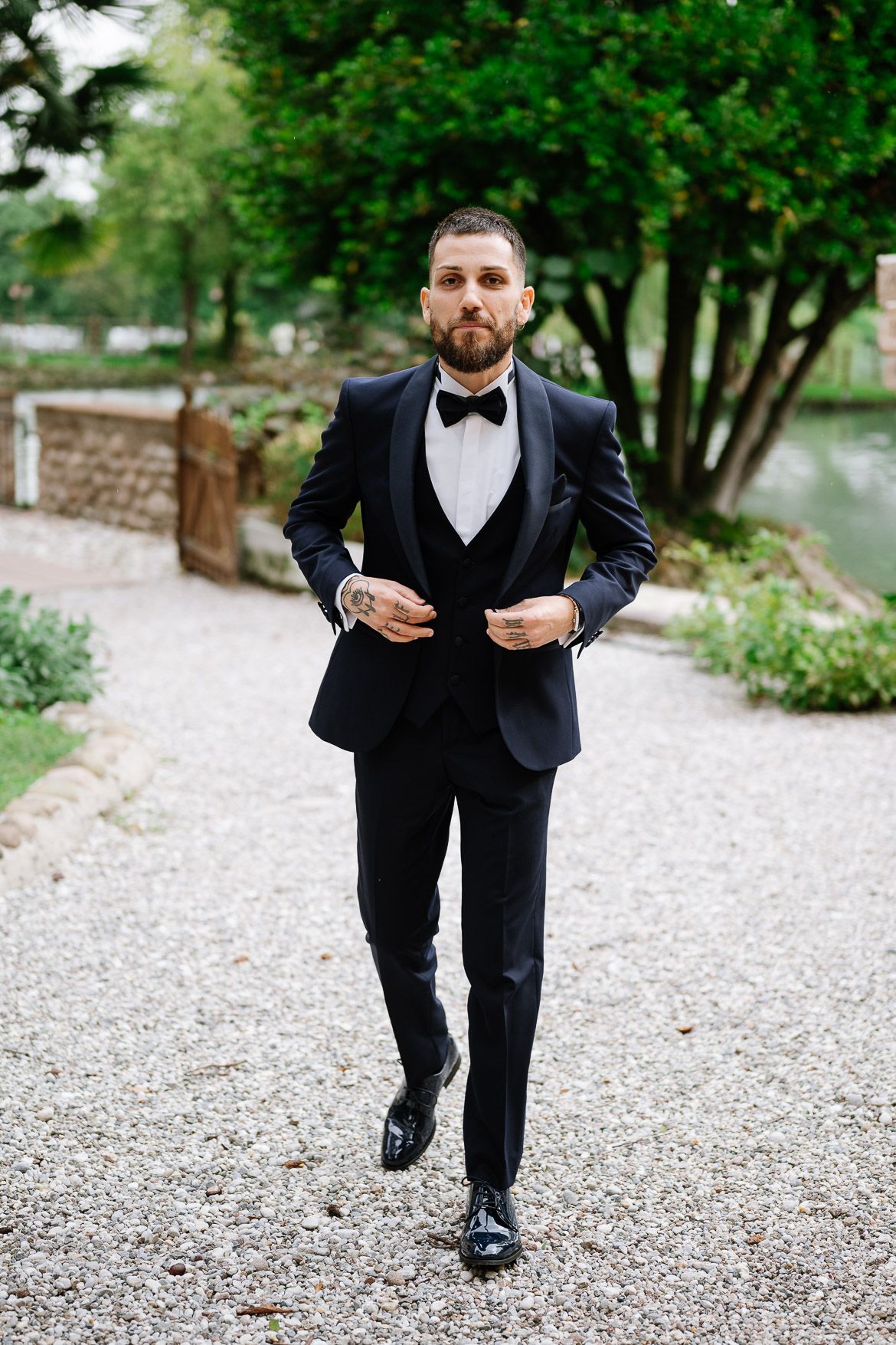 A sequence of formal wedding photos showing dress shoes and suit on a gravel path.