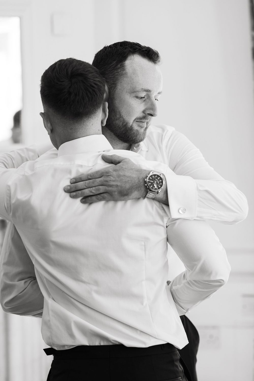 A series of black and white photos showing people in white shirts performing aikido martial arts movements.