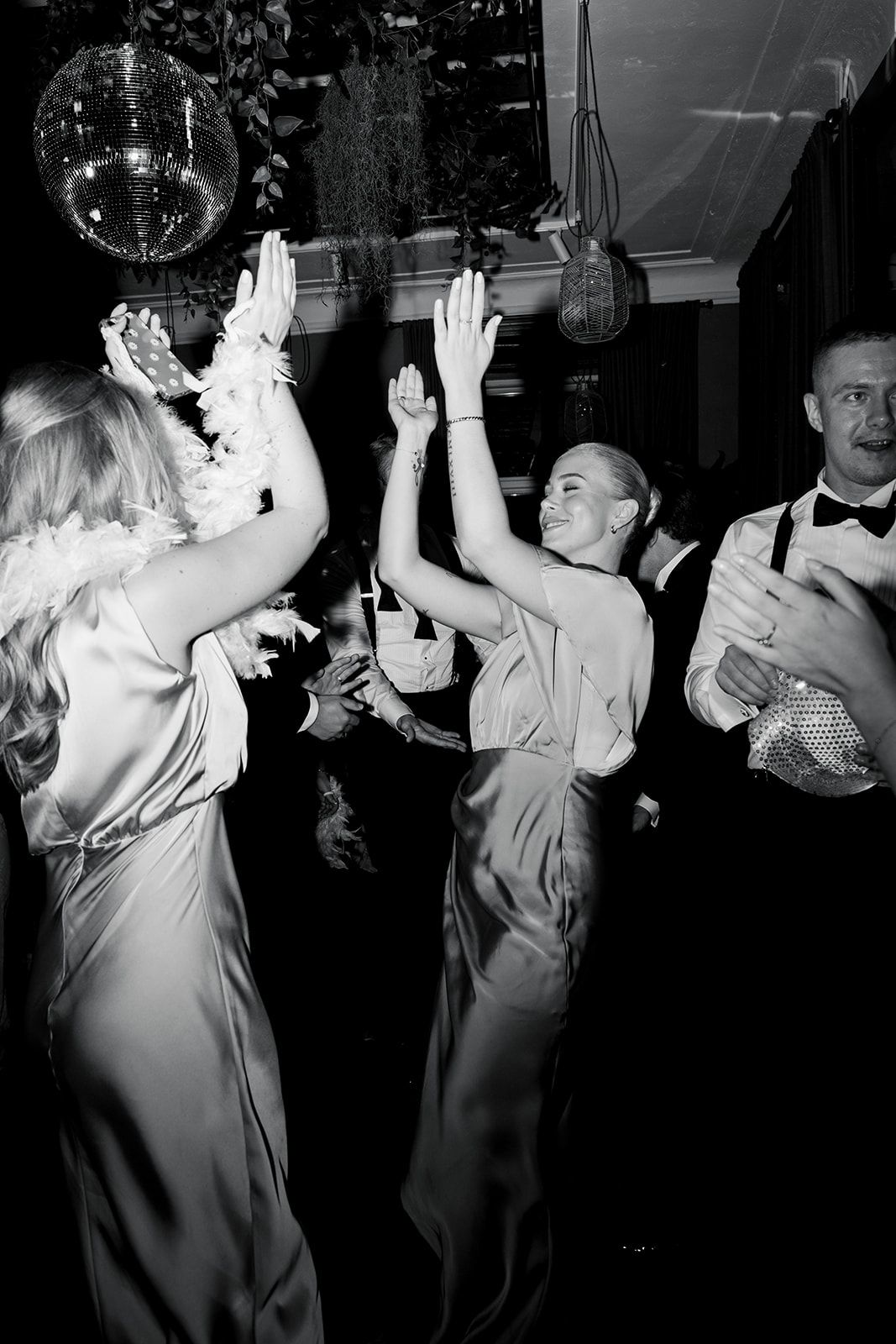 Black and white photo sequence showing a person dancing with raised hands in multiple frames.
