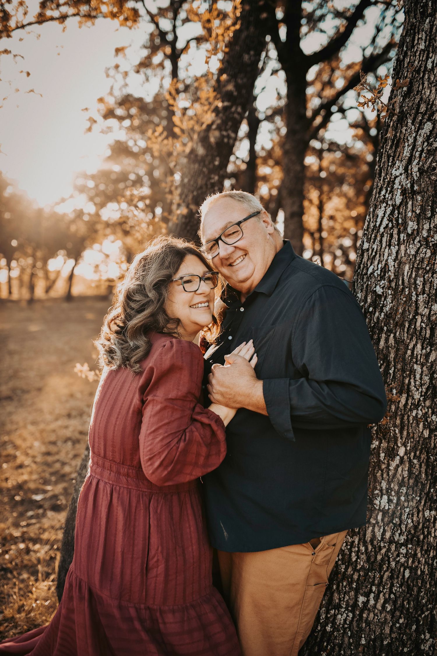 Elegant fall family outfits in the forest with rich autumn tones and layered textures.