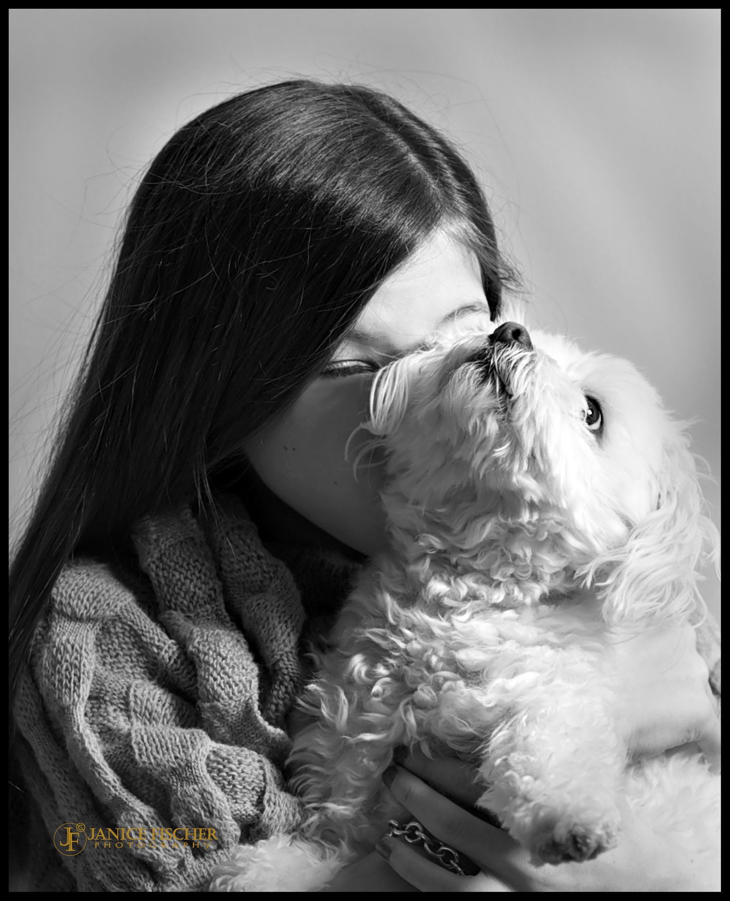 Adorable and touching portrait of a young girl and her pet dog, a Bichon