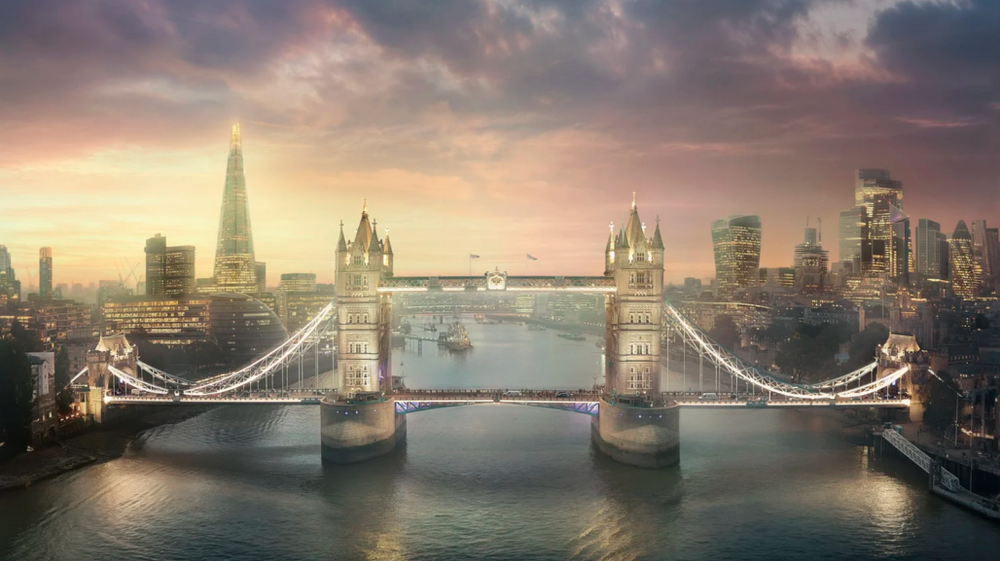Dramatic panorama of Tower Bridge and the Thames River in London during golden hour with moody clouds.