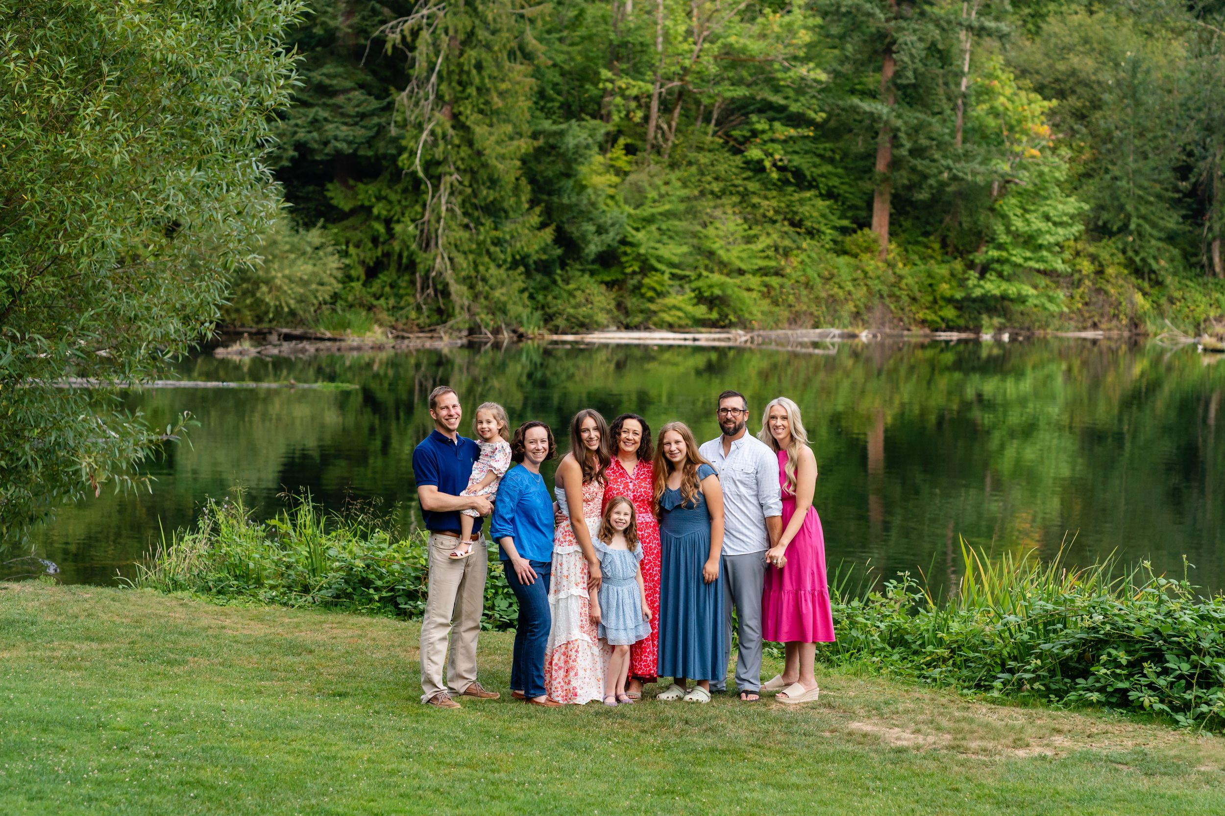 Family poses in front of the lake at Lake Wilderness Arboretum.