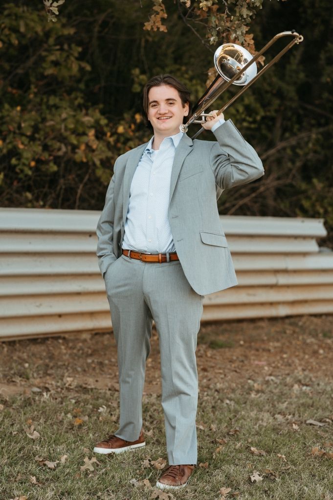 A series of photos showing someone in a light gray suit and white dress shirt posing outdoors on grassy terrain.
