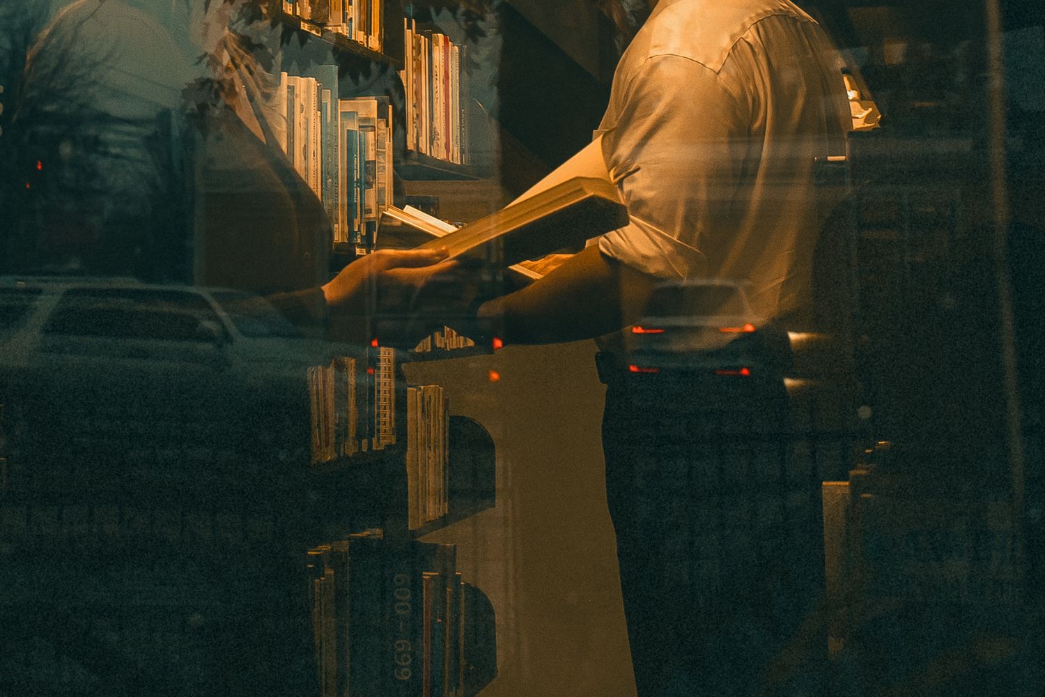 Warm golden lighting illuminates the architectural details of a historic building's interior. North Conway NH public library, Edinburgh