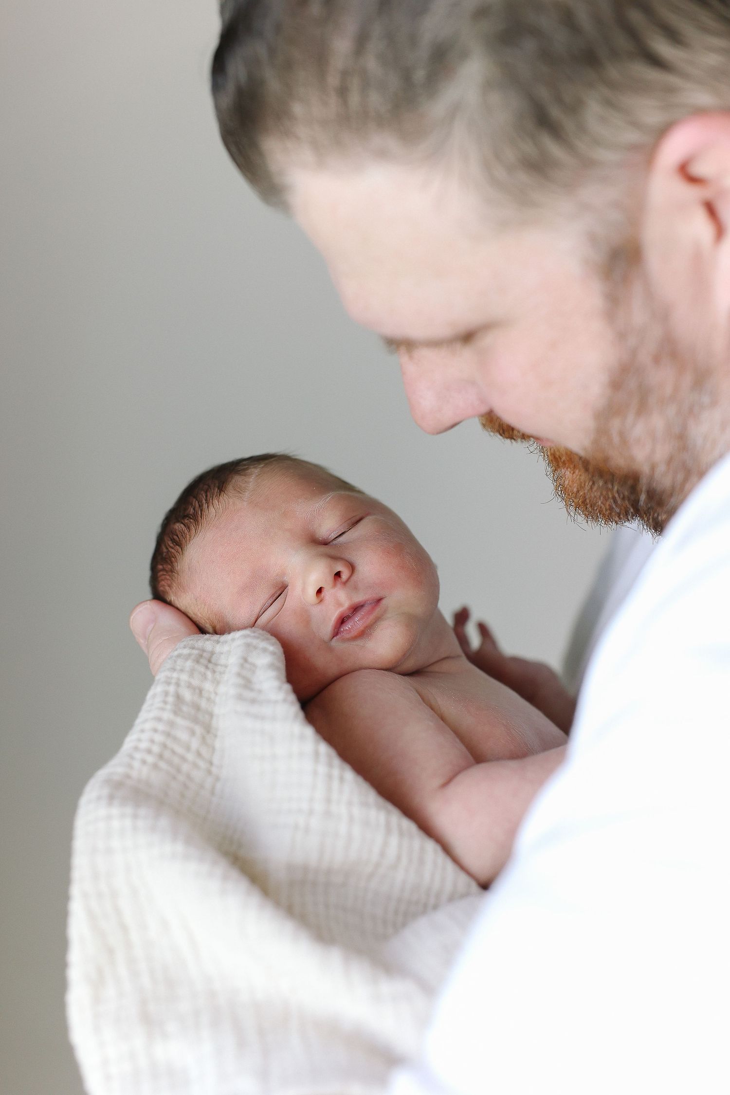 Orange County newborn photos highlighting baby cuddled with dad