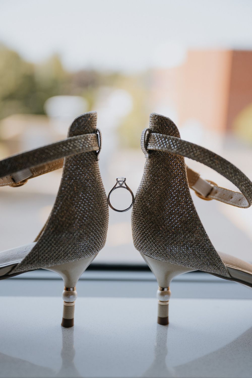 Close-up view of a textured gray kitten heel shoe shown from different angles on a white surface.