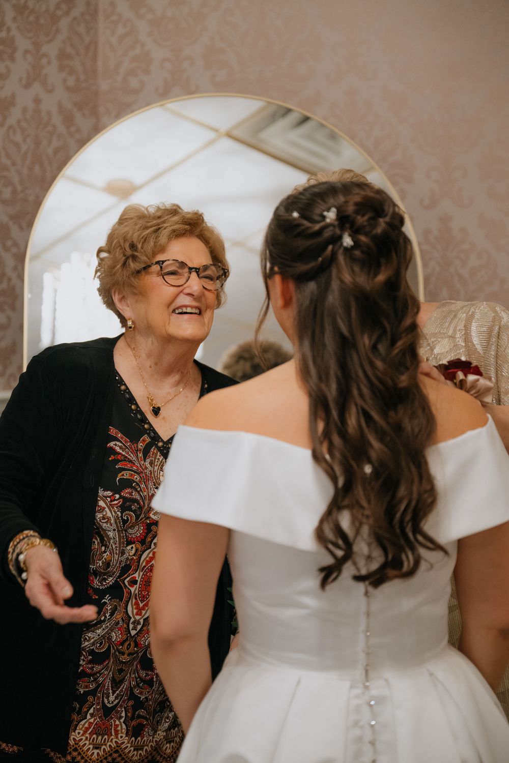 Candid moment showing a joyful interaction between people during a wedding celebration.