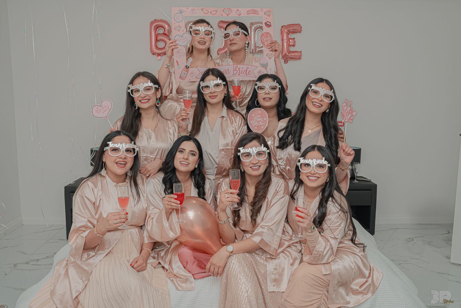 Bride-to-be laughing and enjoying the celebrations at her hen's party, surrounded by her friends in a festive setting.