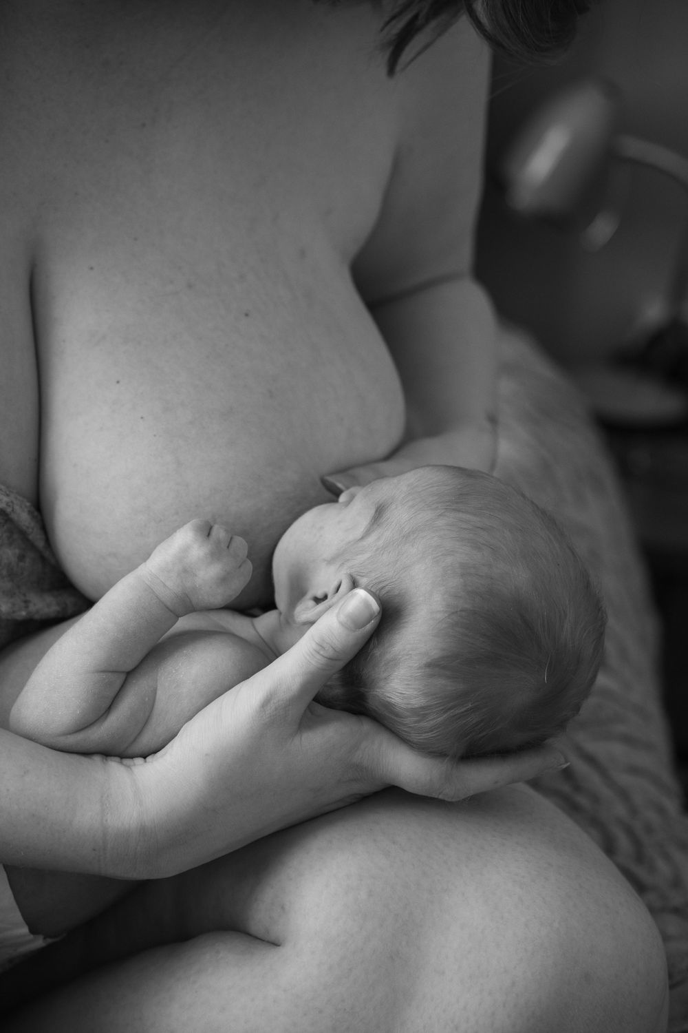 Mother breastfeeding newborn baby