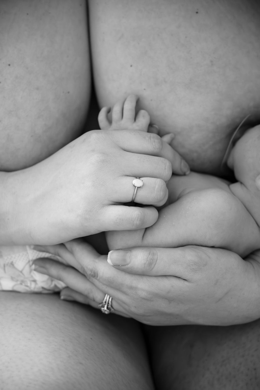Mother holding babys arm