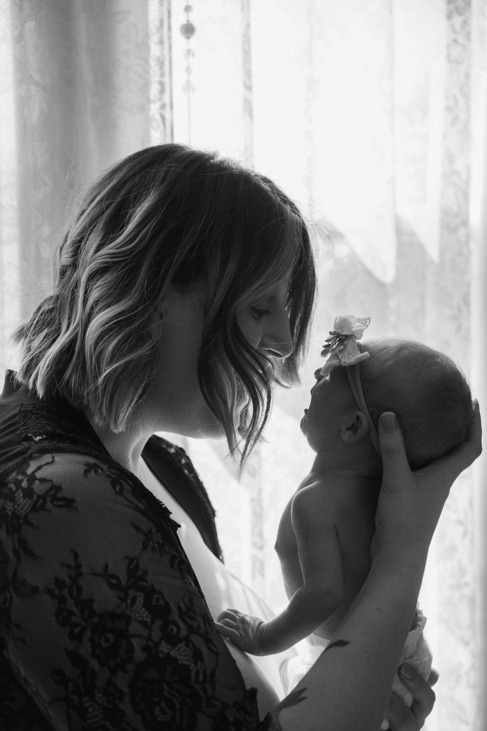 Mother looking at newborn with love