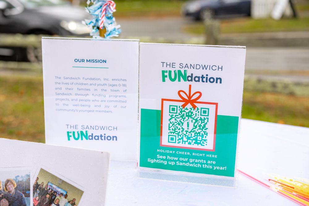 A series of green and white business cards or promotional materials displayed in a row on a surface.