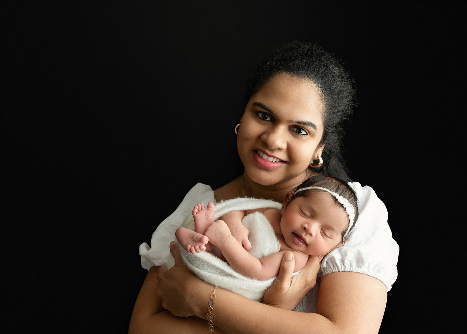 An Indian mom holding their newborn. Greenville SC newborn photographer, Easley, SC newborn photographer