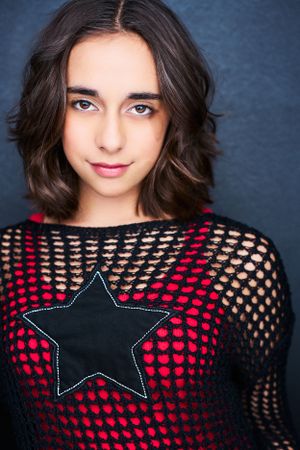Edgy headshot of actor Lena Marano in a black shirt with holes.