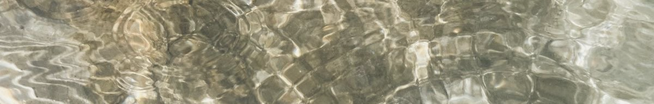 Abstract pattern of rippling water reflections creating wavy lines.