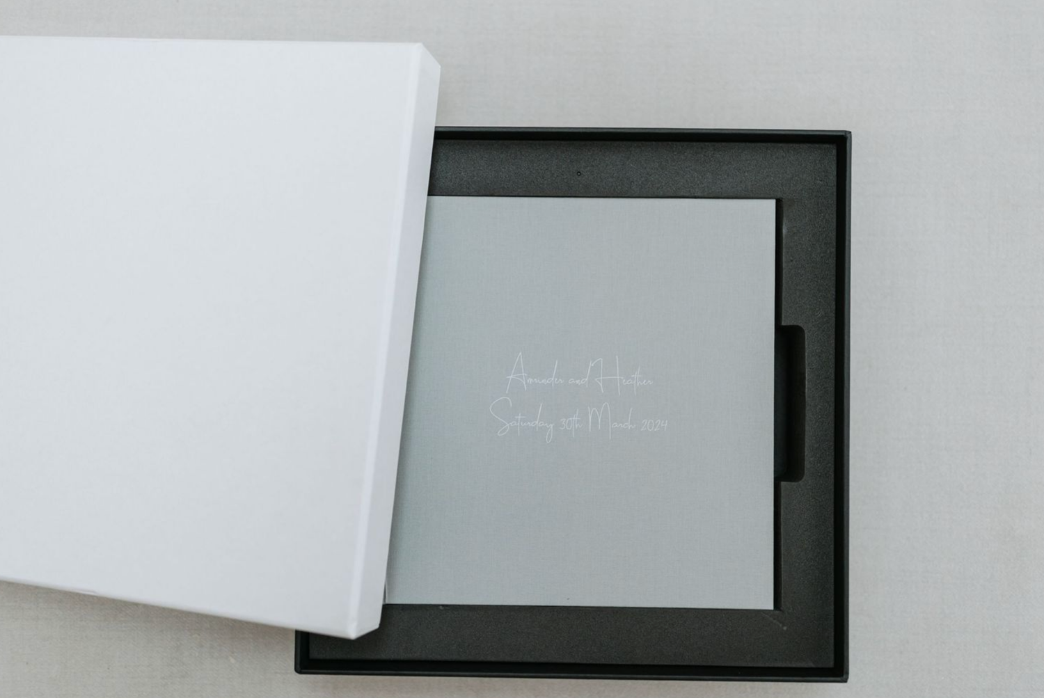 White card or paper is being torn in half against a dark background in a sequential photo series.