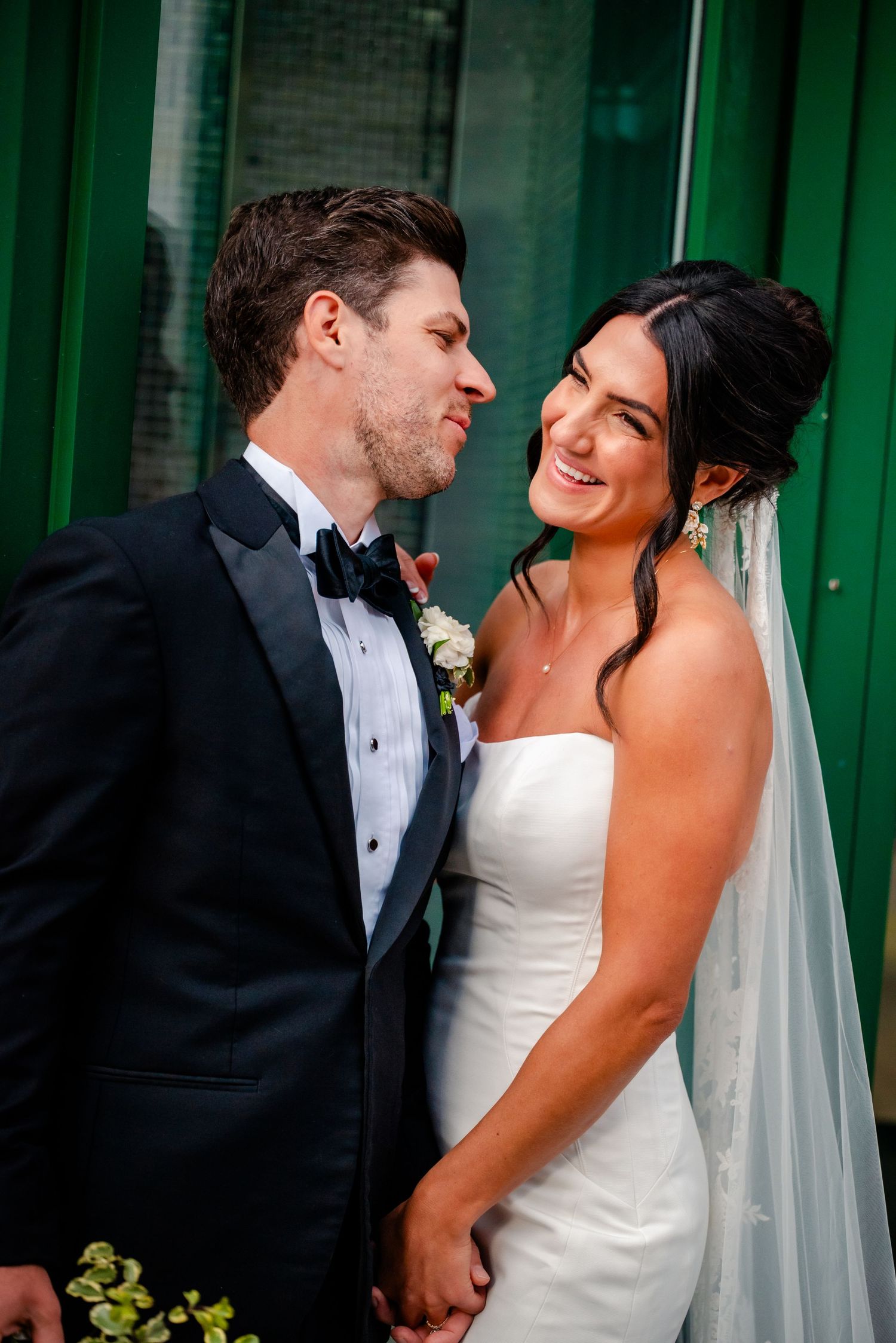 A romantic wedding photo series showing a couple in formal attire sharing intimate moments against a green background.