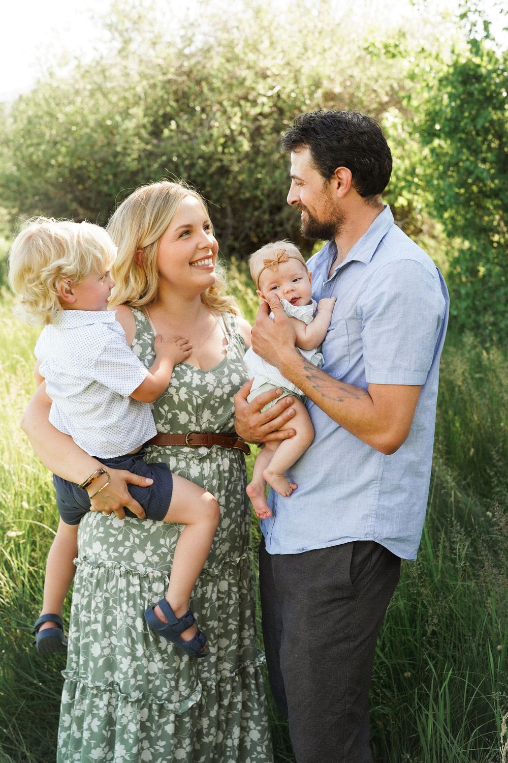 A family shares joyful moments together in a series of candid photos taken in tall grass during golden hour.
