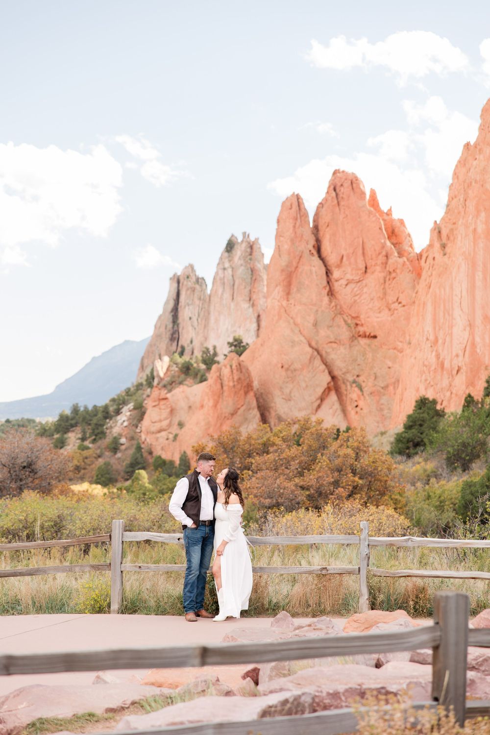 Scenic engagement photos at Garden of the Gods with dramatic sandstone formations and mountain views.