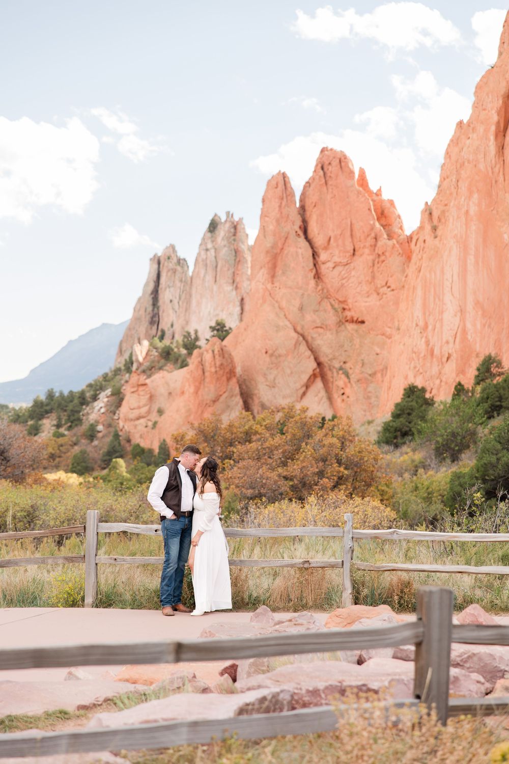 Scenic engagement photos at Garden of the Gods with towering sandstone formations and blue skies.