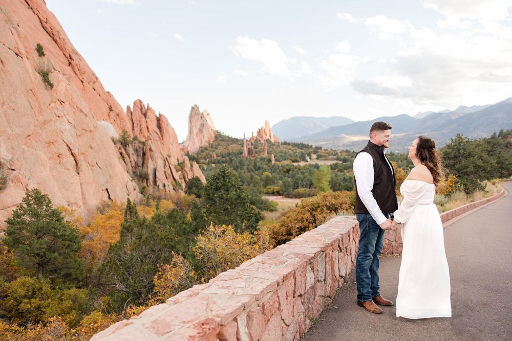 Panoramic view of red rock formations and mountains at Garden of the Gods in Colorado Springs during sunset.
