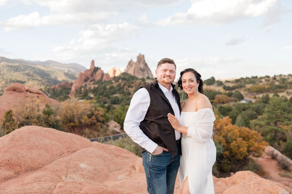 Newlyweds share an intimate moment against the backdrop of Garden of the Gods' majestic red rock landscape.