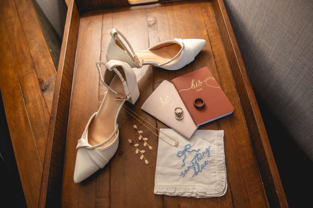 Vintage leather shoes and accessories arranged artistically in wooden boxes with handwritten notes and natural lighting.
